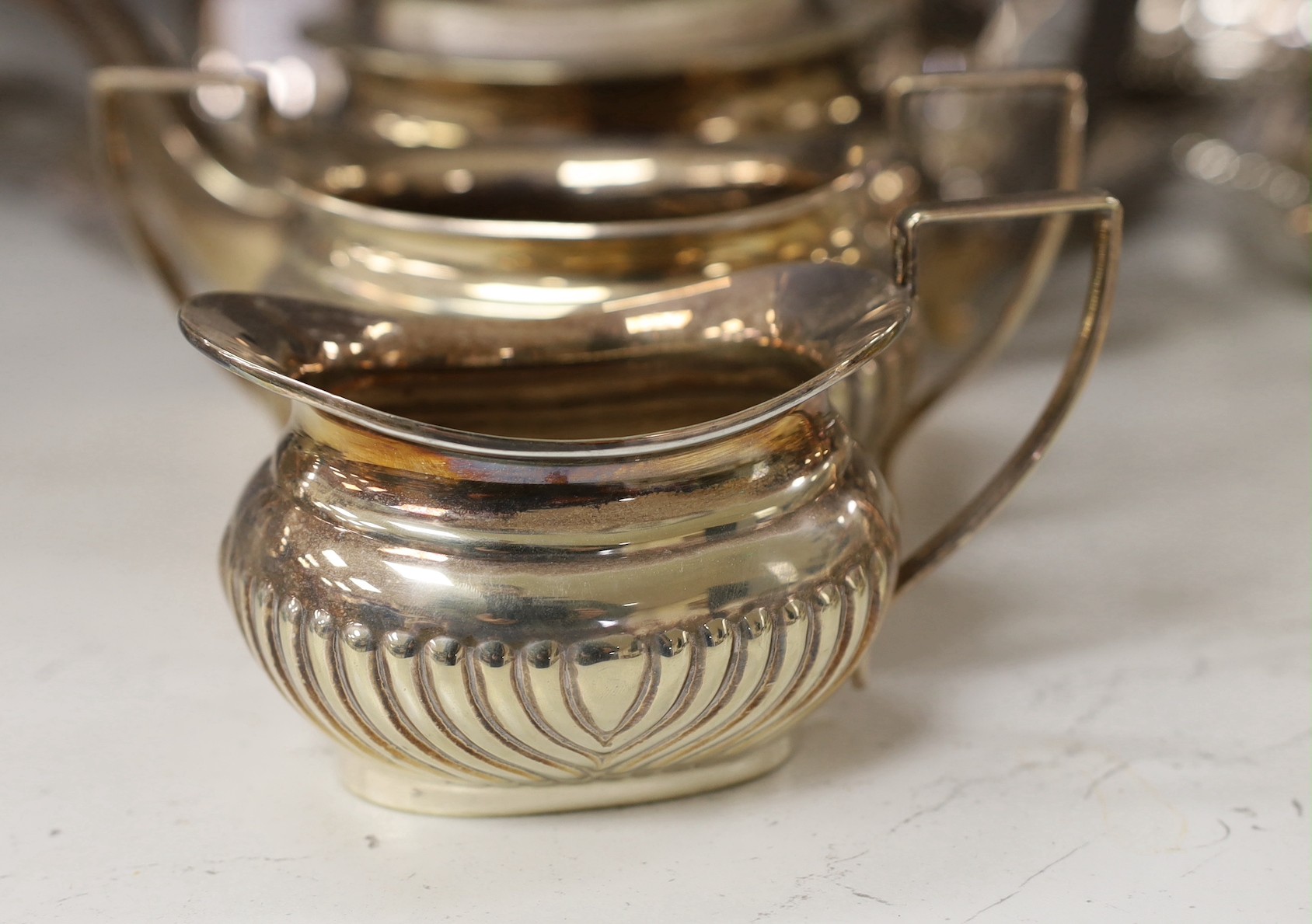 A large quantity of plated wares including two entree dishes and covers, a three-piece tea set etc.
